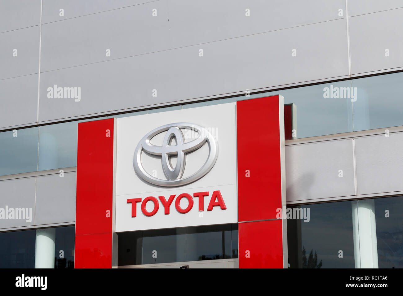 Toyota logo in a dealership building. Toyota is the world's leader in hybrid electric cars Stock Photo
