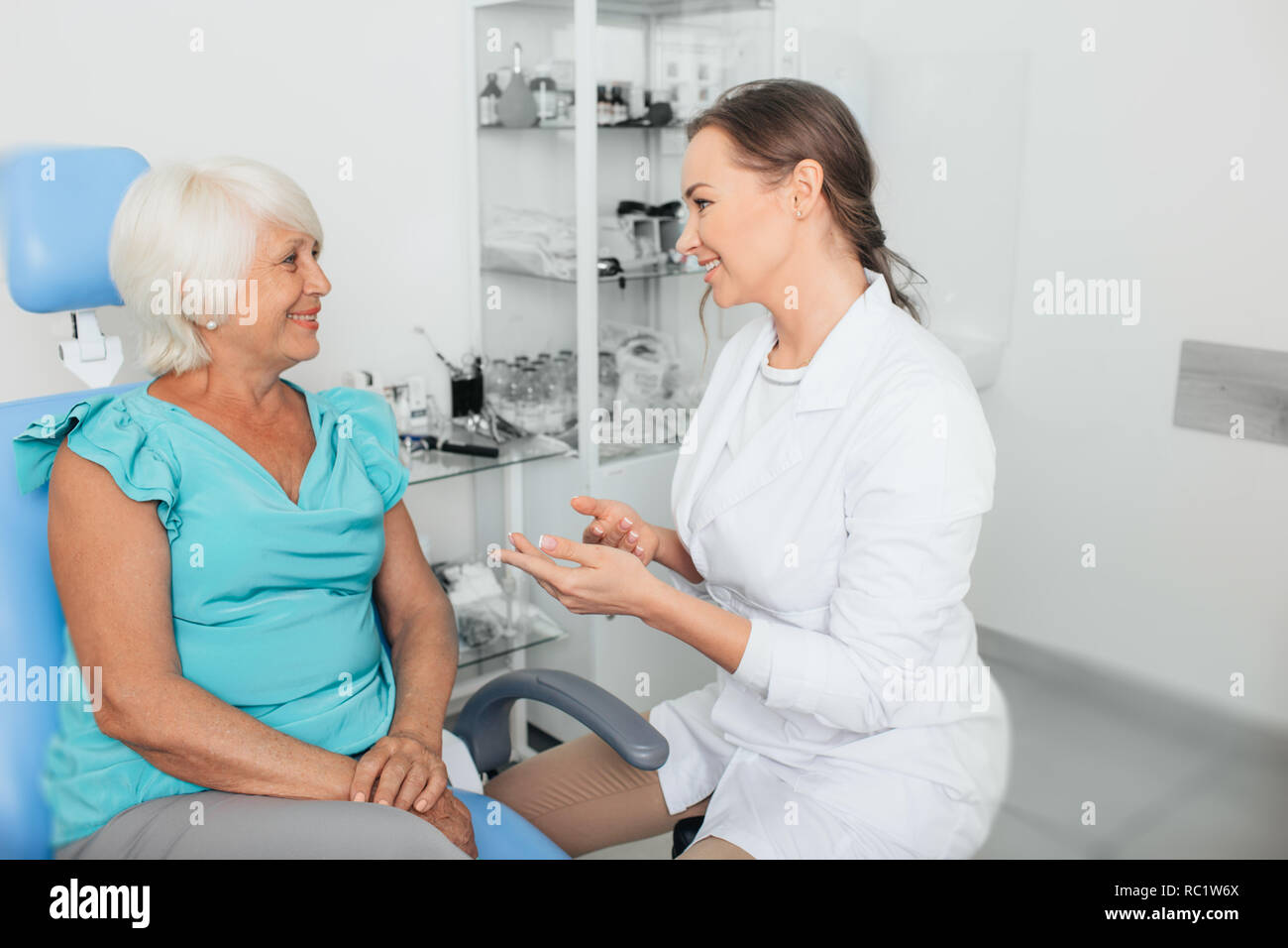 doctor talking with aged woman in doctor's office. medical support elderly patient Stock Photo