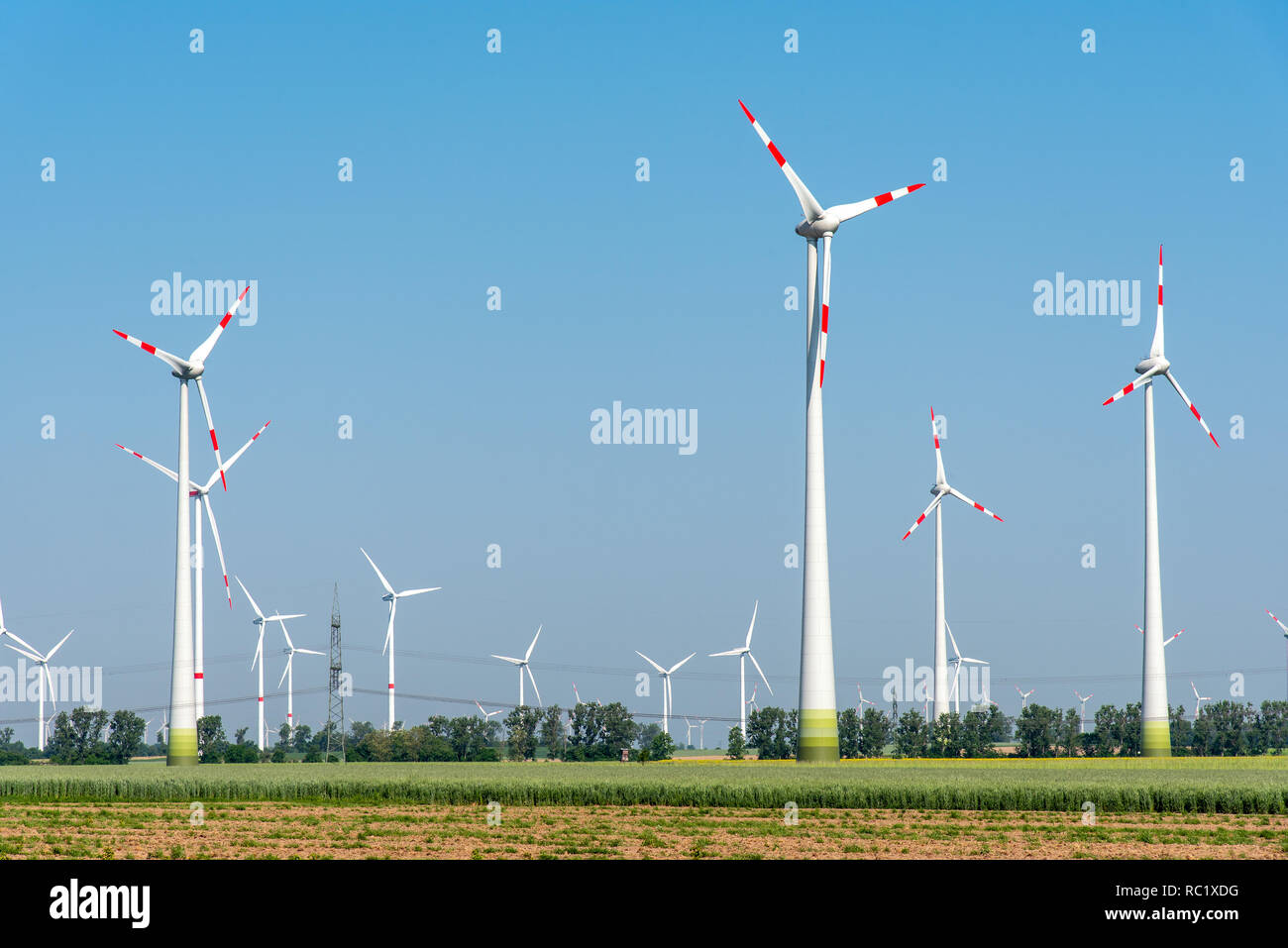 Wind power plants in the fields seen in rural Germany Stock Photo
