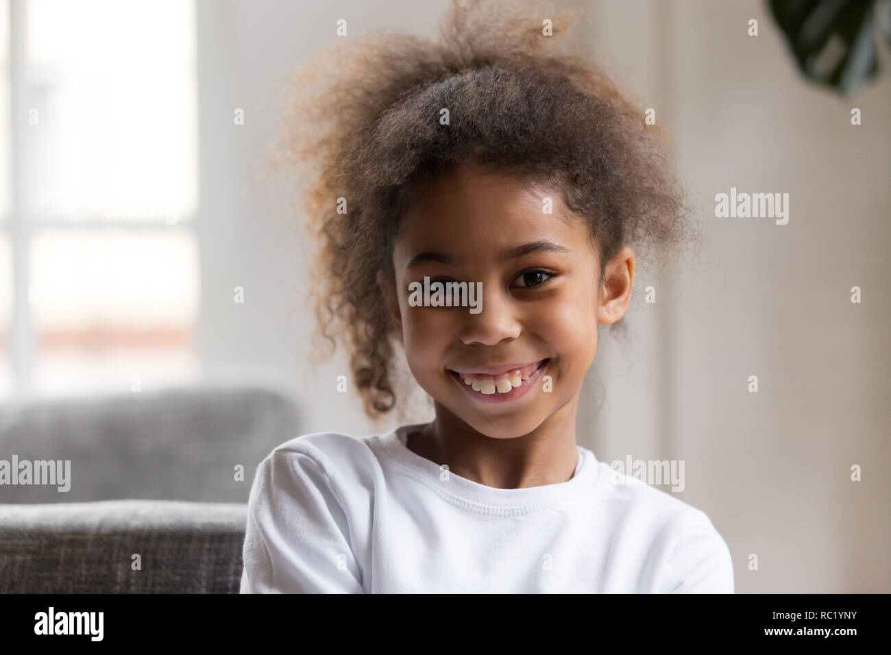 Cute funny little african american girl looking at camera Stock Photo ...