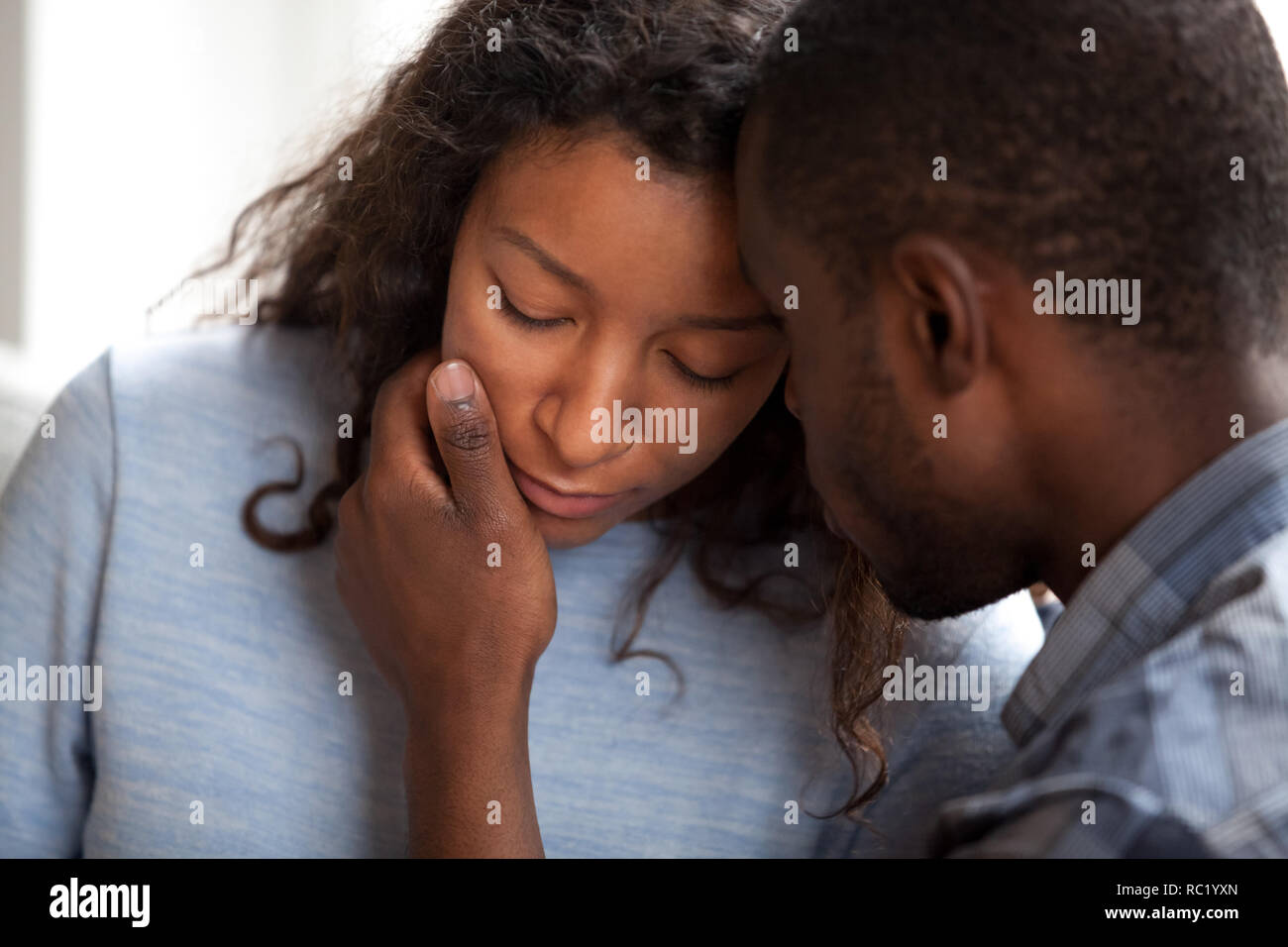 Loving african american husband apologizing comforting sad upset Stock Photo