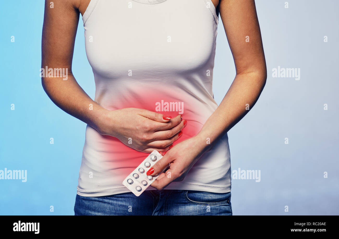 Female suffering from strong stomach ache abdominal pain Stock Photo