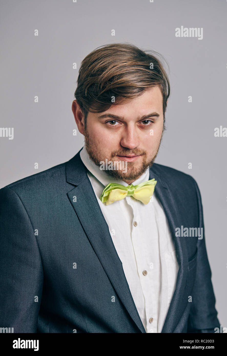 hipster model man in stylish clothes posing on studio background Stock Photo
