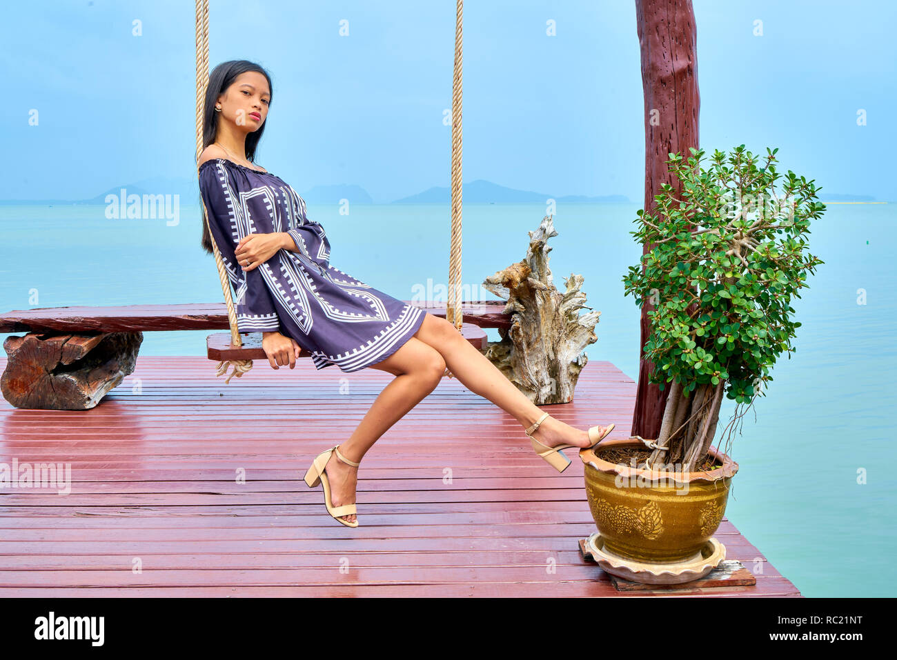 Pensive woman sitting on swing hi-res stock photography and images - Alamy