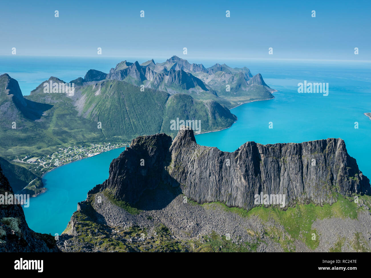 View over fjord Örnfjord, village Fjordgard, peak of Segla (left) and Hesten, seen from mountain Grytetippen, island Senja, Troms, Norway Stock Photo