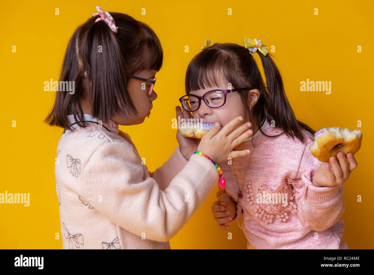 Curious good-looking little twins having meal together Stock Photo