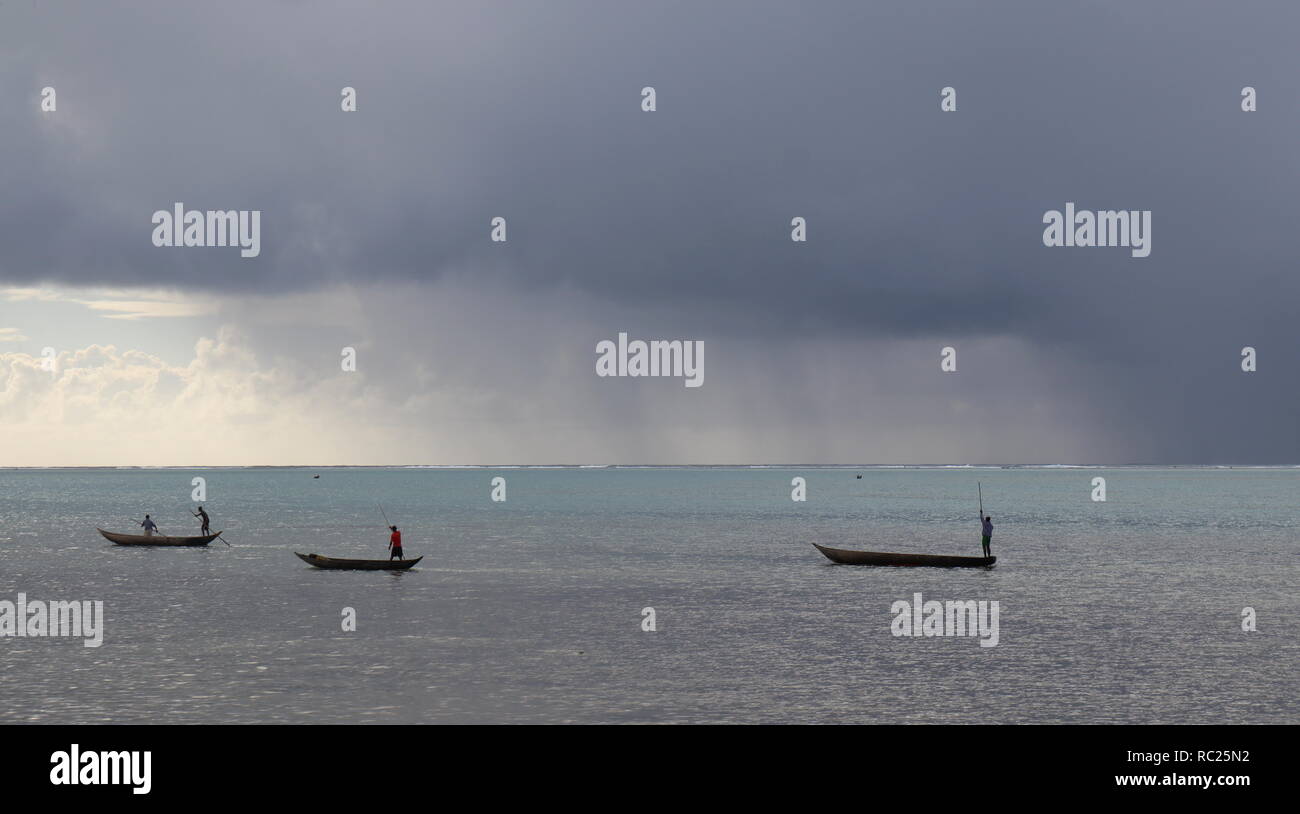 Pirogues chased by rain in Ile aux Nattes, Madagascar, Indian Ocean Stock Photo