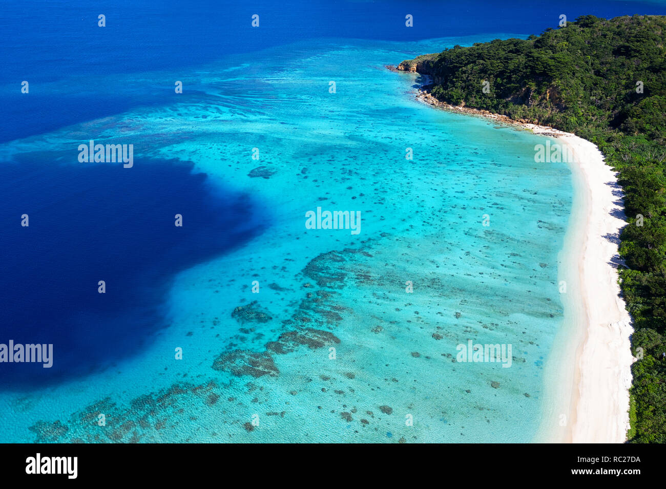 Aerial view of paradise beach, coral reef and turquoise waters at Iriomote jima, Japan, taken by drone Stock Photo