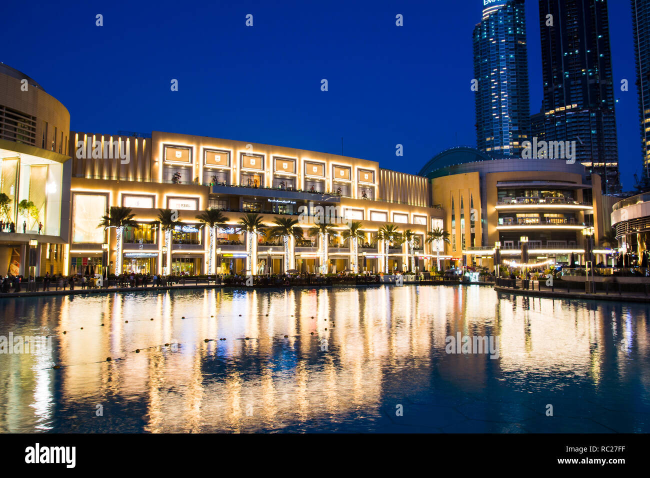 DUBAI, UNITED ARAB EMIRATES - FEBRUARY 5, 2018: Dubai mall modern architecture reflected in the fountain at blue hour. The Dubai Mall is the largest m Stock Photo