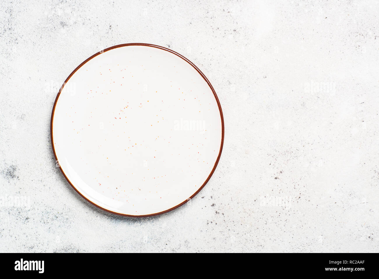 White craft ceramic plate on stone table top view Stock Photo - Alamy