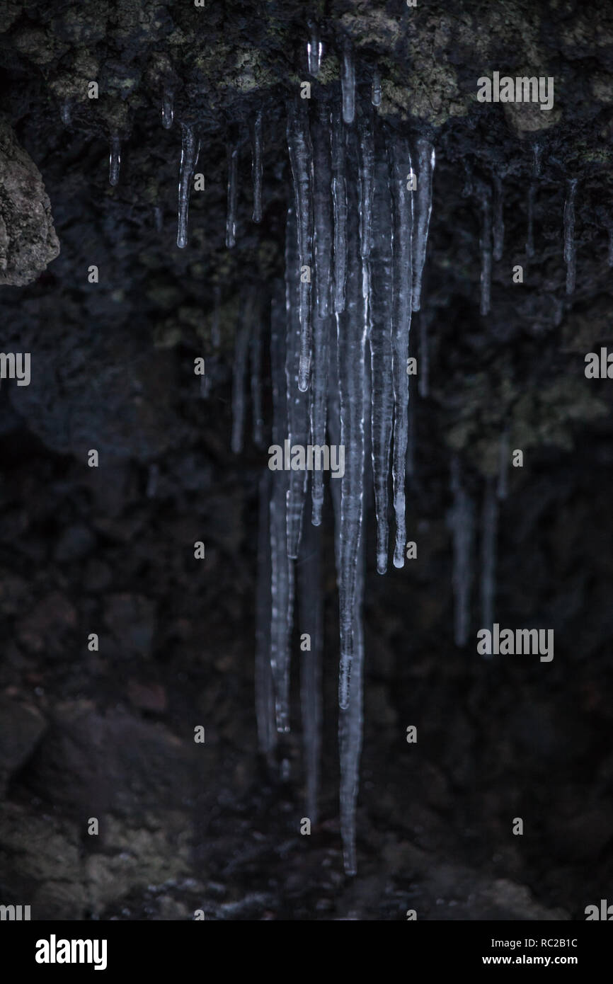 A Stalactite Hanging From Cave Ceiling Stock Photo