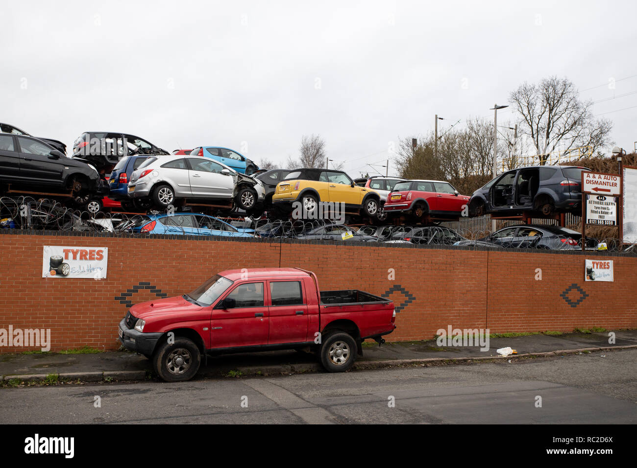 A shot of cars stacked high at scrapyard in West Bromwich Stock Photo