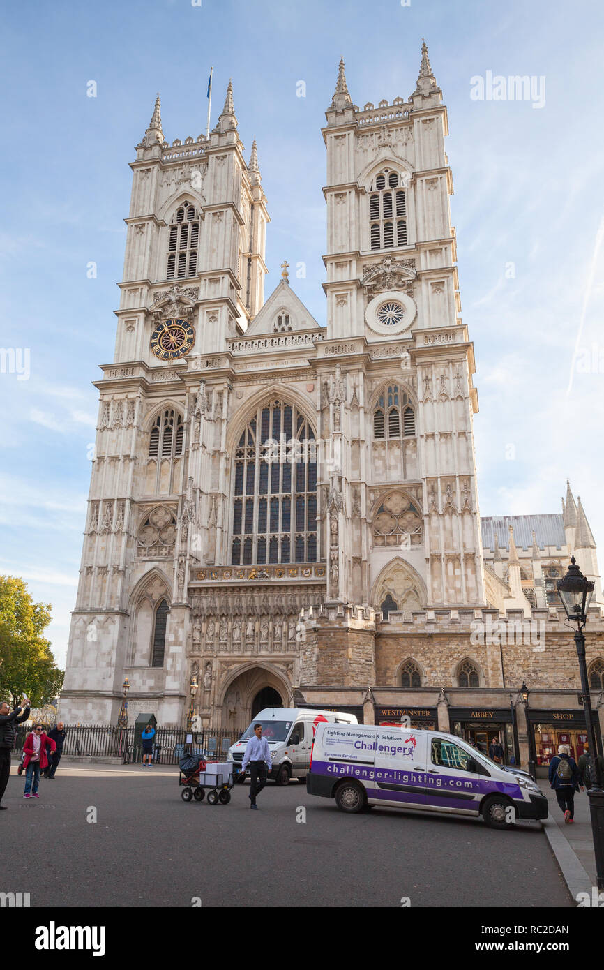 London, United Kingdom - October 30, 2017: Ordinary people walk near Westminster Abbey facade. One of the most popular landmarks of London, United Kin Stock Photo