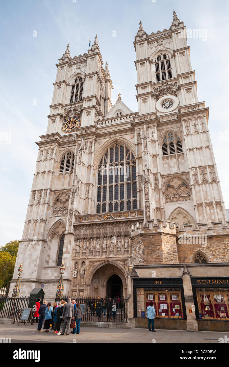 London, United Kingdom - October 30, 2017: Ordinary people walk near Westminster Abbey main facade. One of the most popular landmarks of London, Unite Stock Photo