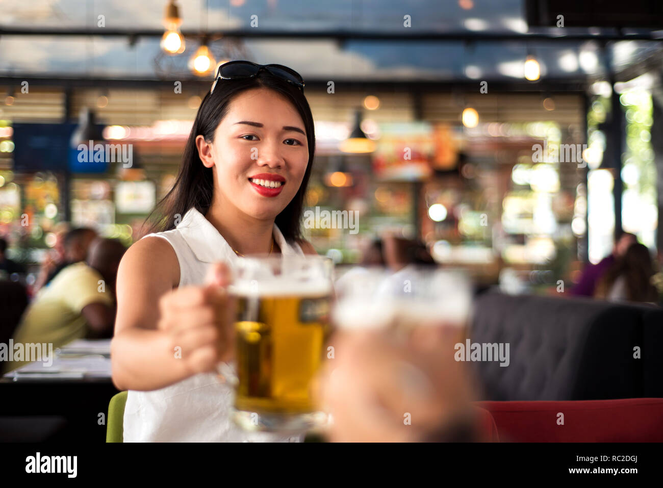 Asian girl having a beer in the bar Stock Photo