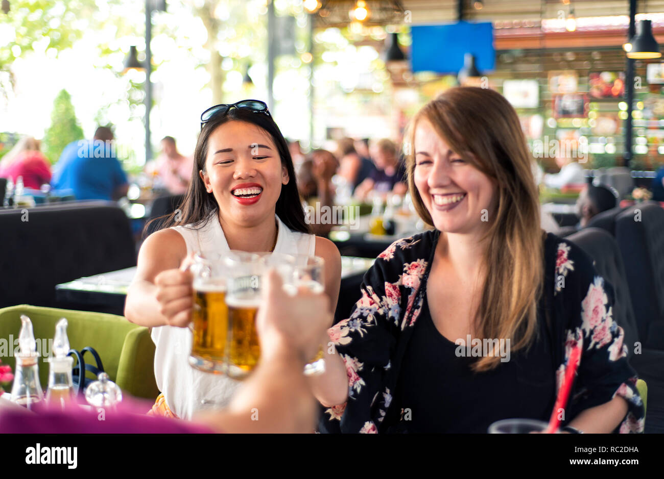 Happy friends drinking beer in the bar Stock Photo
