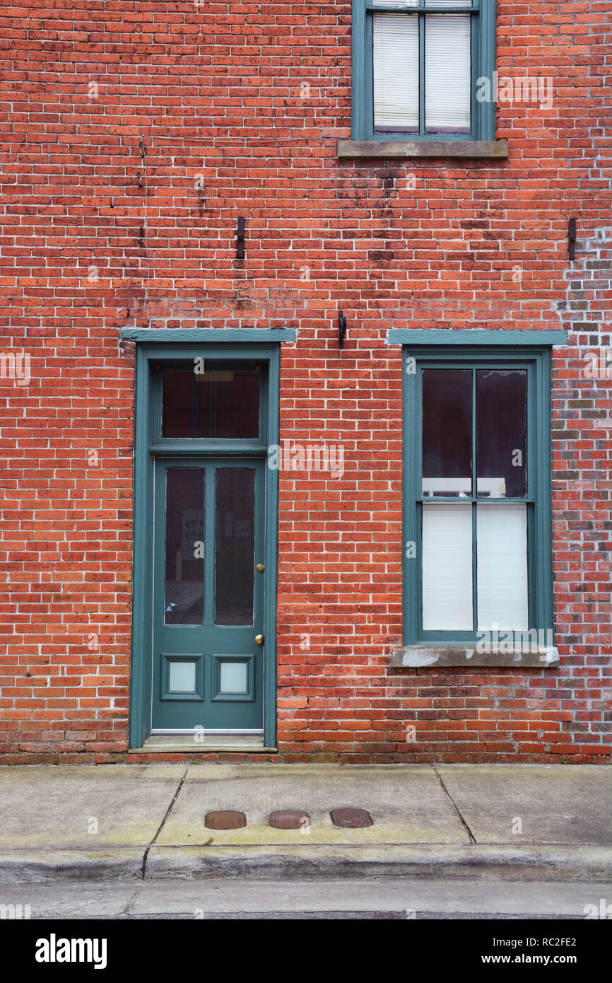 An Old Wood Frame Door And Window Painted Green Against A