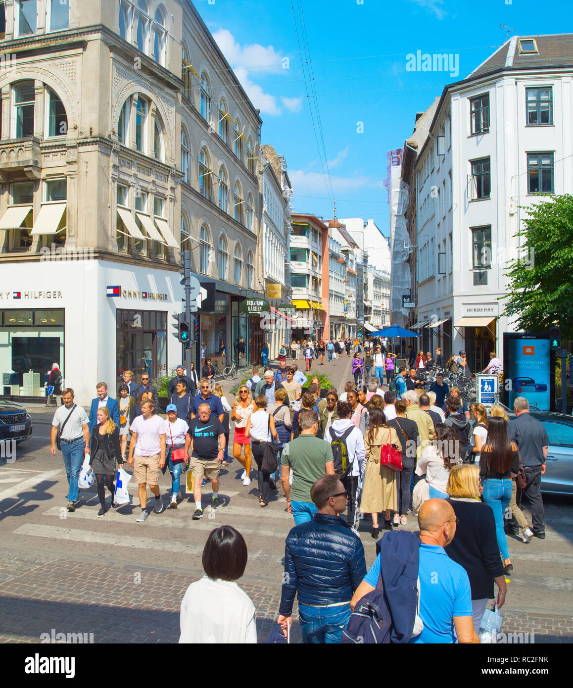 COPENHAGEN, DENMARK - JUNE 14, 2018: People crossing the road at Copenhagen central shopping street. Copenhagen is the capital of Denmark. Stock Photo