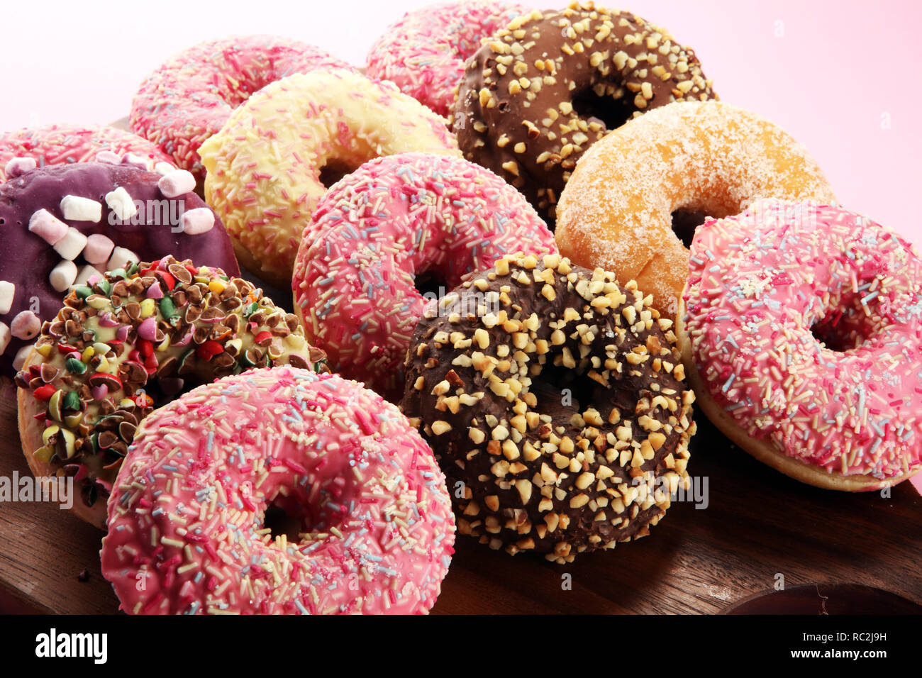 assorted donuts with chocolate frosted, pink glazed and sprinkles ...