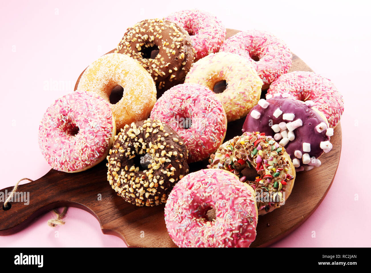 assorted donuts with chocolate frosted, pink glazed and sprinkles ...