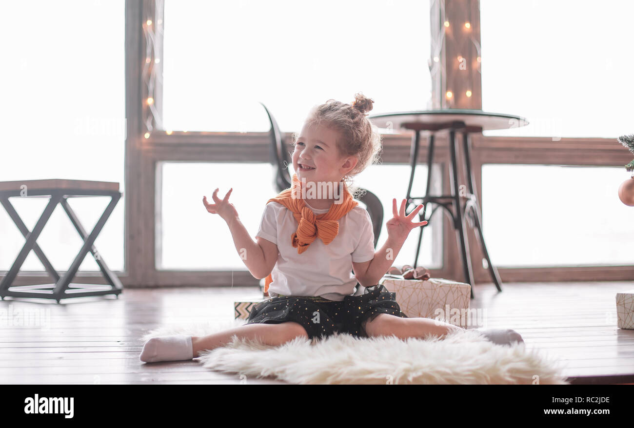 little girl playing sitting on the carpet in the living room Stock ...