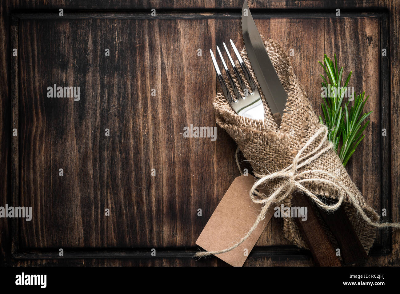 Table setting fork knife and wooden plate Stock Photo - Alamy