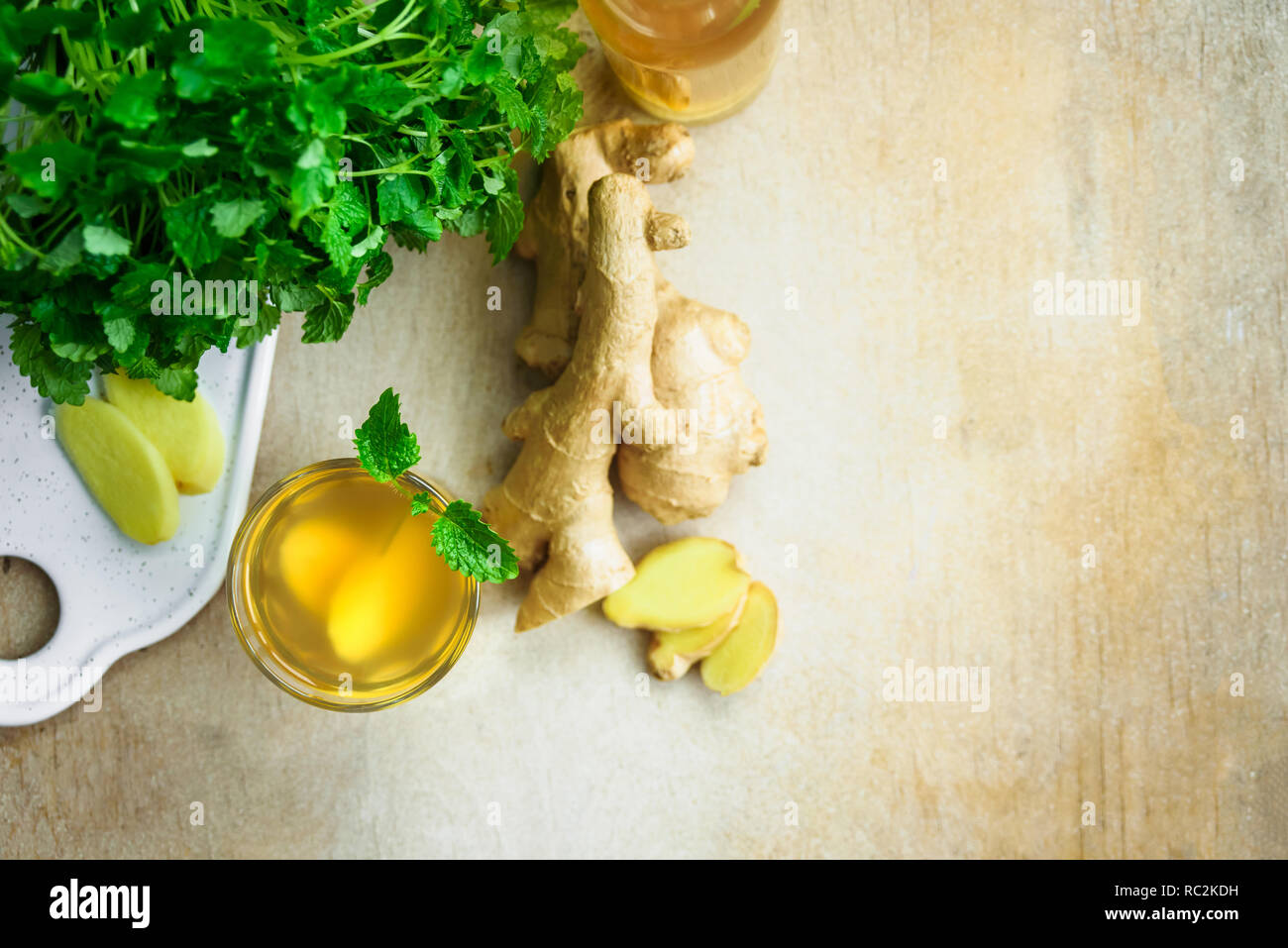 Glass with ginger detox water and ingredients near it. Wooden background. Top view. Copy space Stock Photo