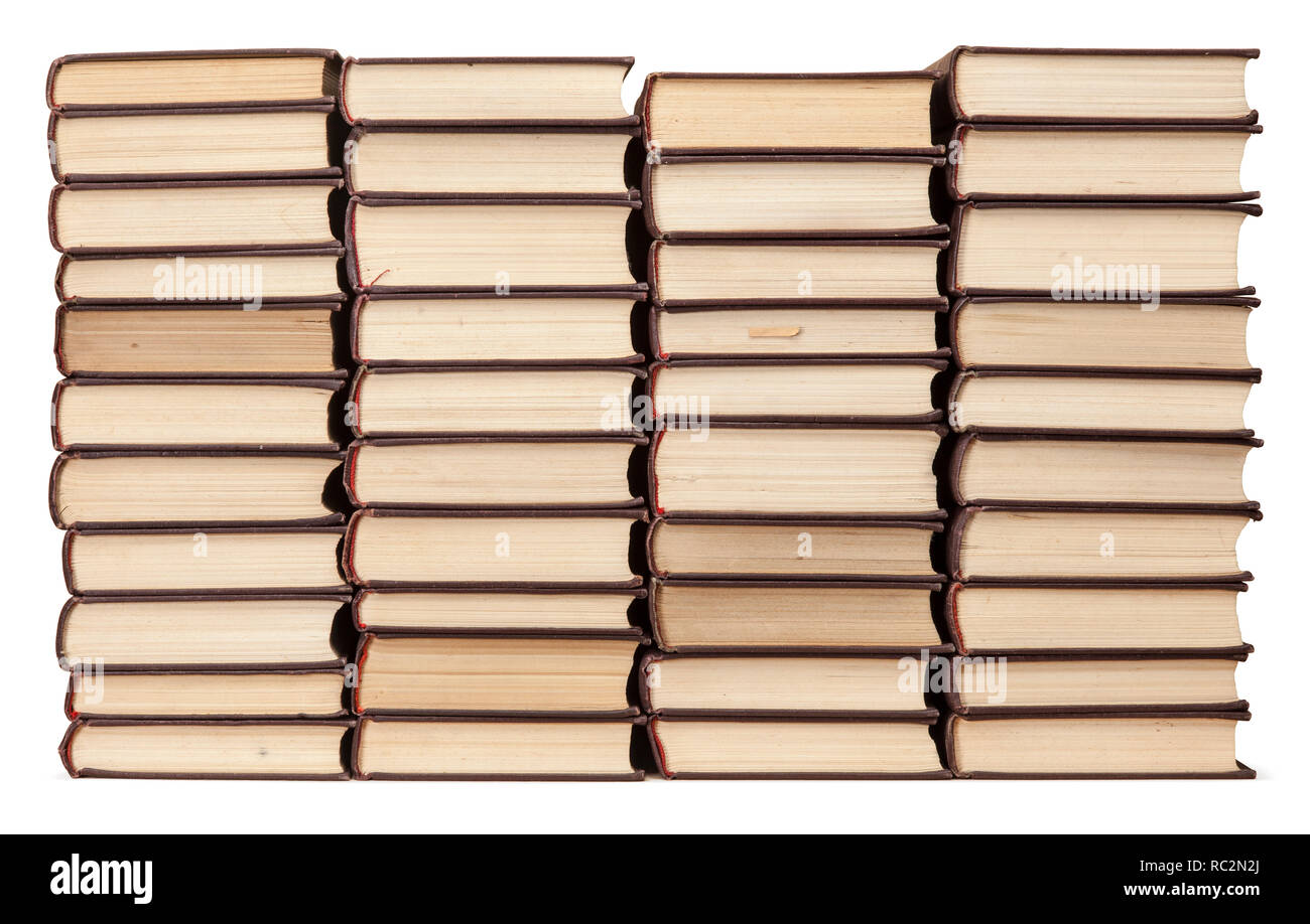 Stacks of old books with yellowed pages isolated on white background. Library or bookstore concept. Stock Photo