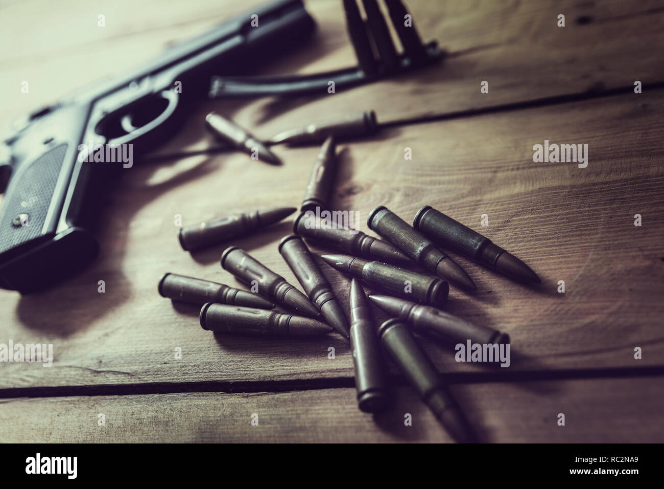 gun and ammunition on wooden table Stock Photo