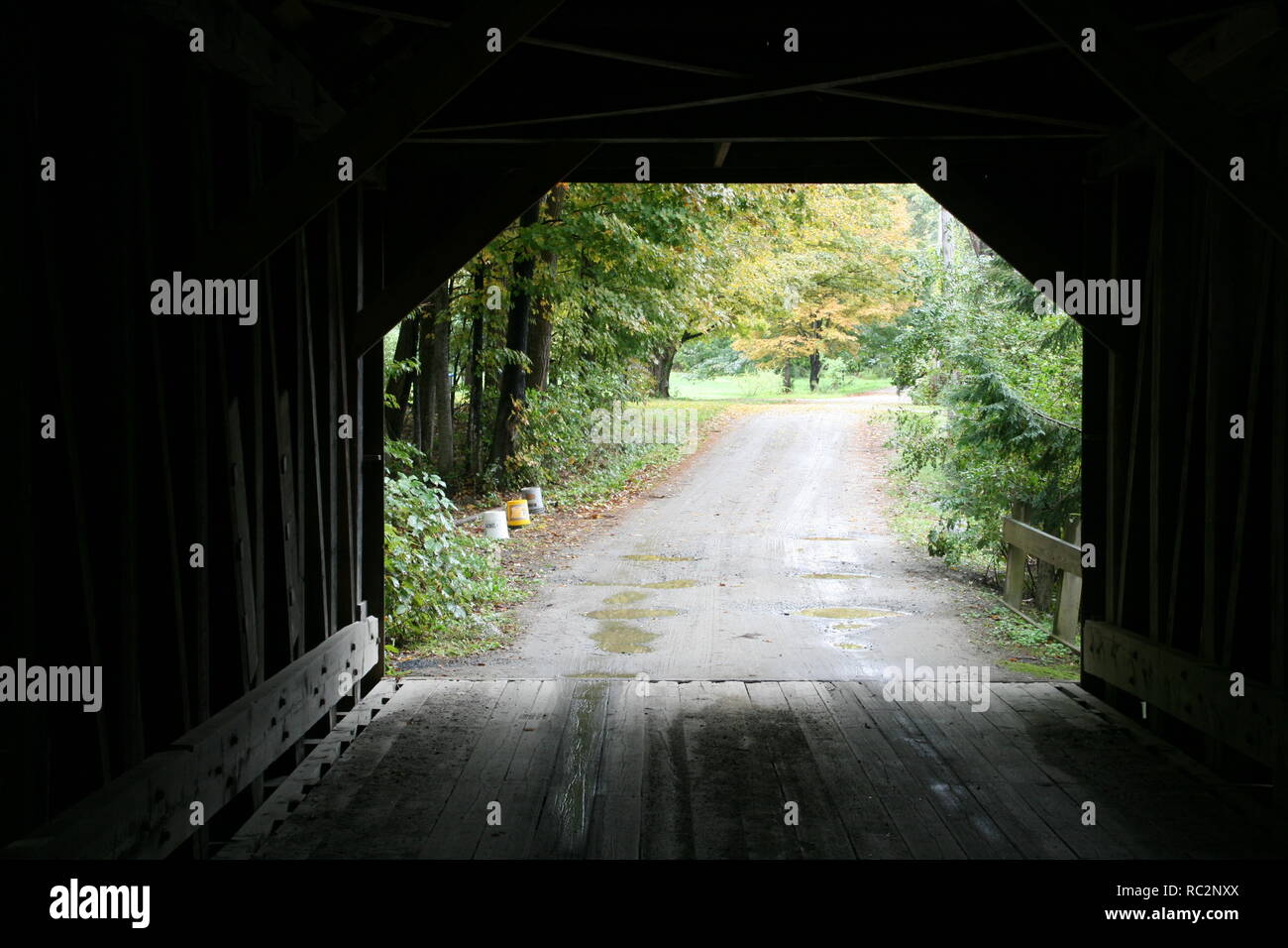 Blow Me Down Covered Bridge, SW of Plainfield in Cornish, New Hampshire. Silhouette view from inside bridge showing tree line driveway beyond. Stock Photo