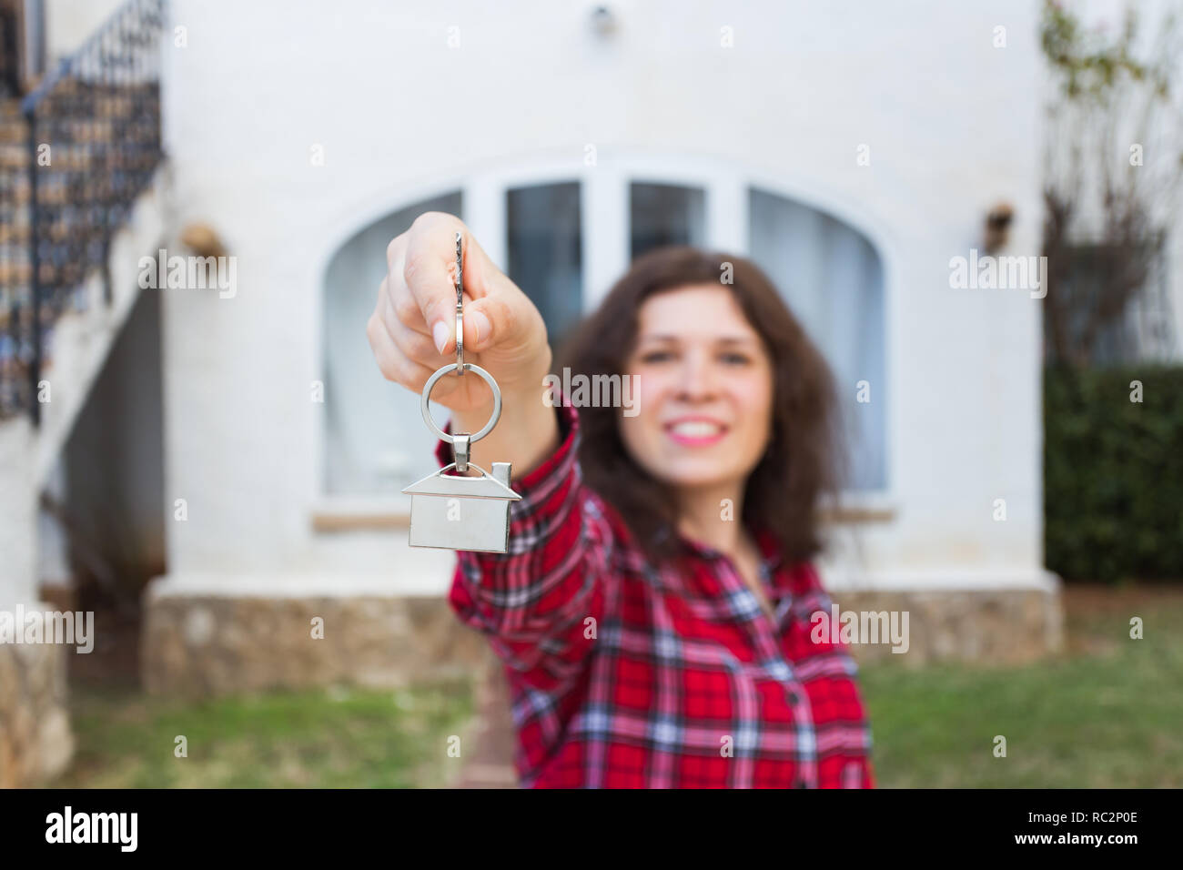 Real estate and property concept - Happy young woman in front of new ...