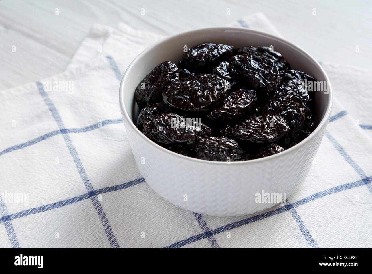 Dry prunes in a bowl, side view. Closeup.a Stock Photo Alamy