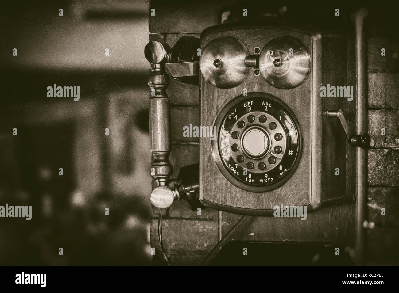 Old vintage wall mount telephone with brass bells in monochrome - retro photography Stock Photo