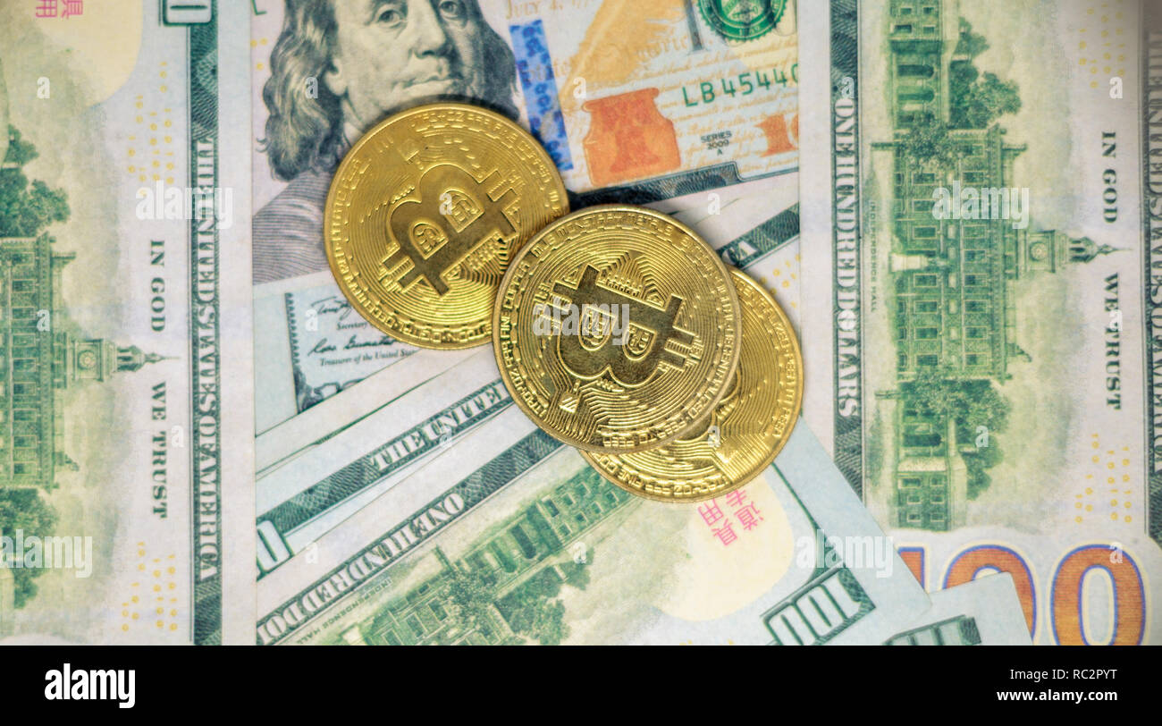 100 US dollars and bitcoins Stock Photo