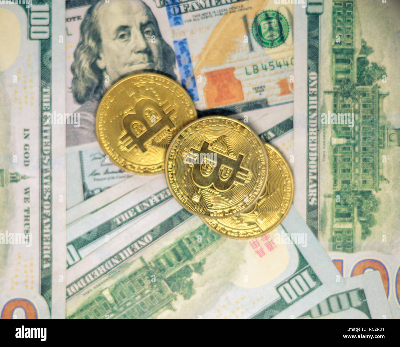Digital currency bitcoin and US dollar bills Stock Photo