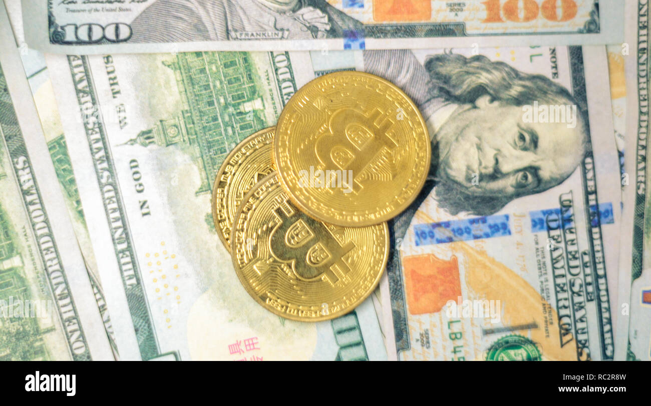 US one hundred dollar bills and bitcoins Stock Photo
