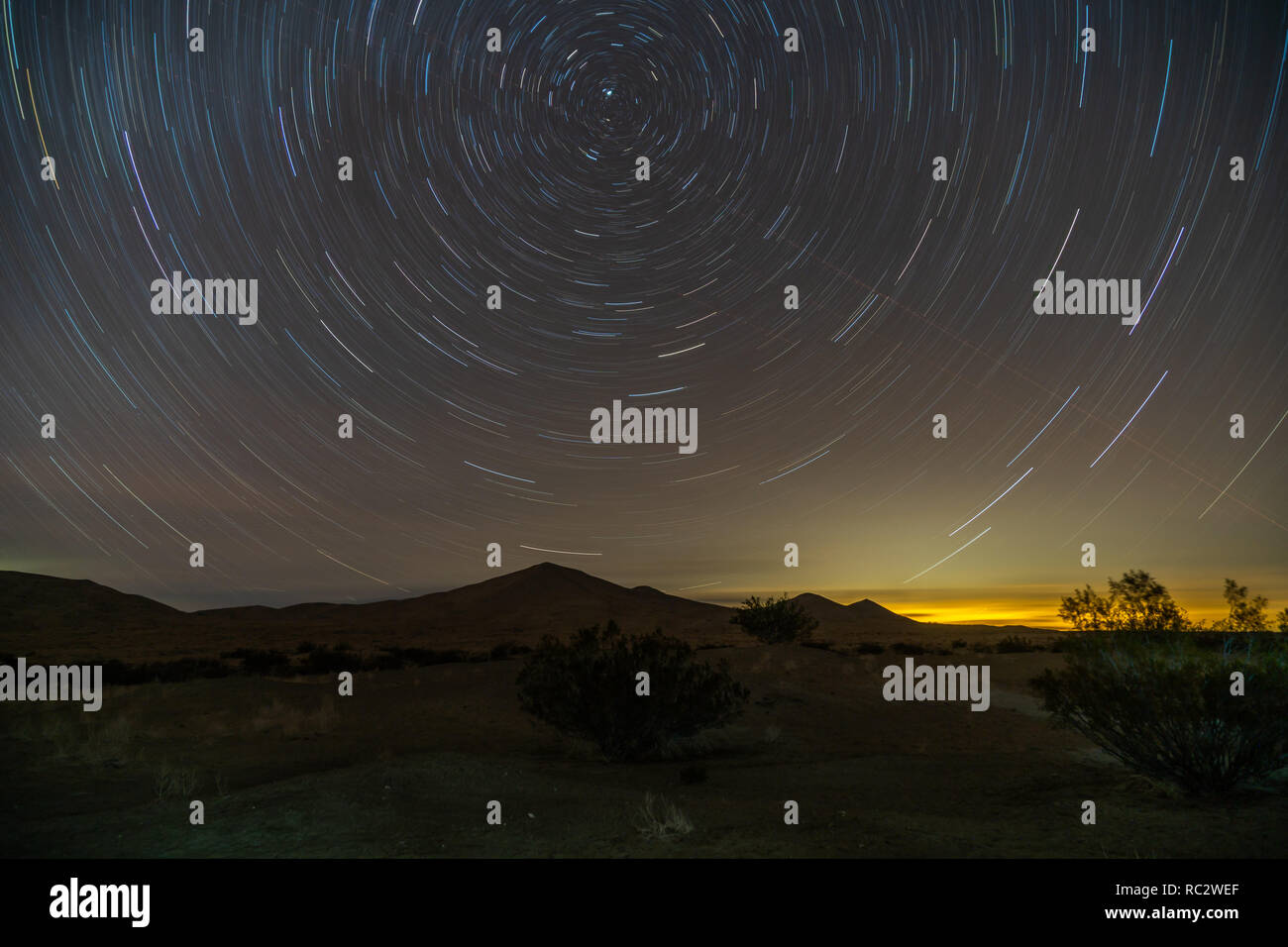Star trails in the night sky at Kelso Dunes, Las Vegas night light on the Horizon, Mojave