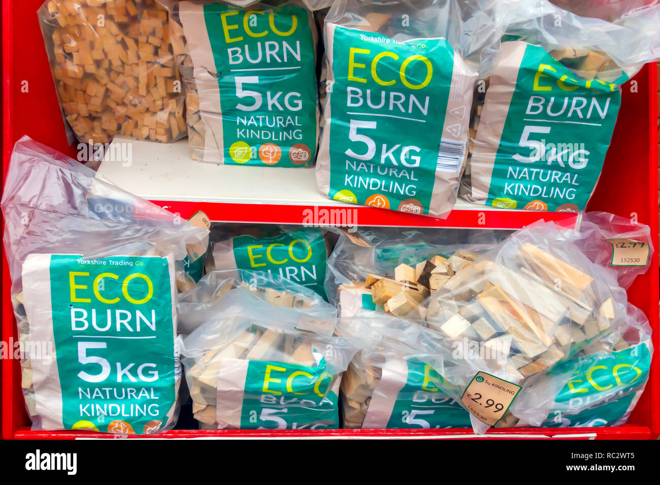 So called Eco Burn Natural Kindling Wood bundled in 5Kg plastic bags for sale in a UK shop Stock Photo