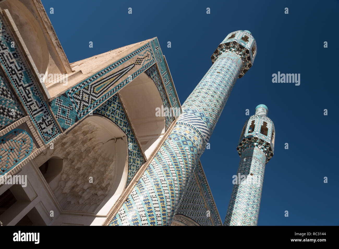 View of twin minarets and portico with decorative tiled mosaics, part of Shah Nematollah Vali Shrine, Iran Stock Photo
