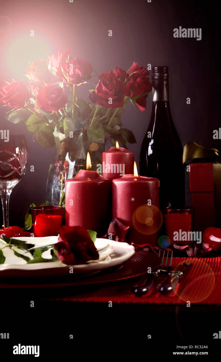 Romantic Valentine's Day Table Setting for two with red roses, gift and ...
