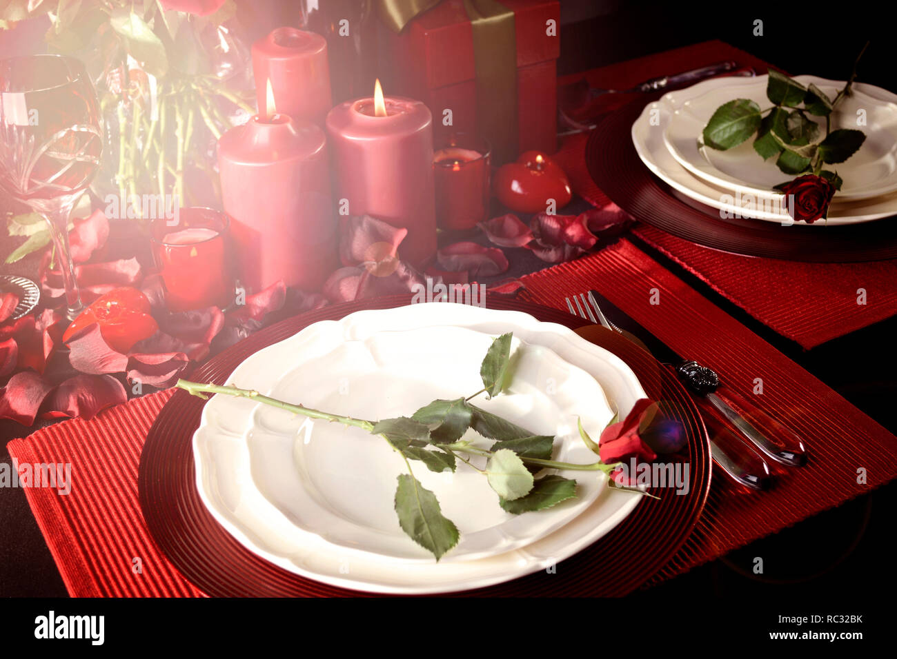 Romantic Valentine's Day Table Setting for two with red roses, gift and ...