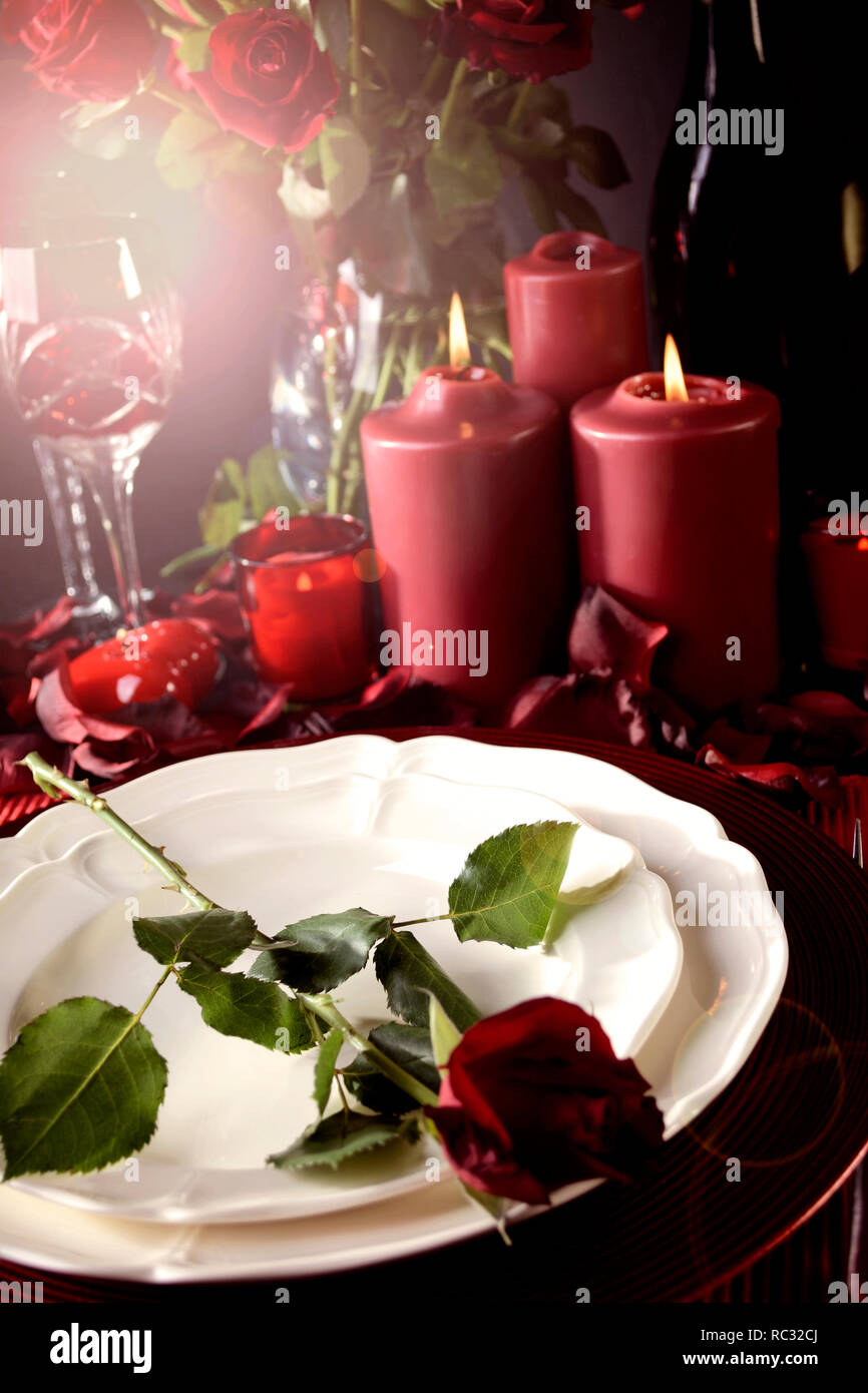 Romantic Valentine's Day Table Setting for two with red roses, gift and ...