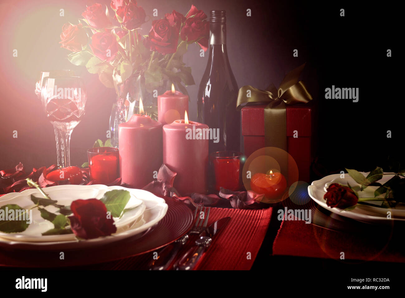 Romantic Valentine's Day Table Setting for two with red roses, gift and ...