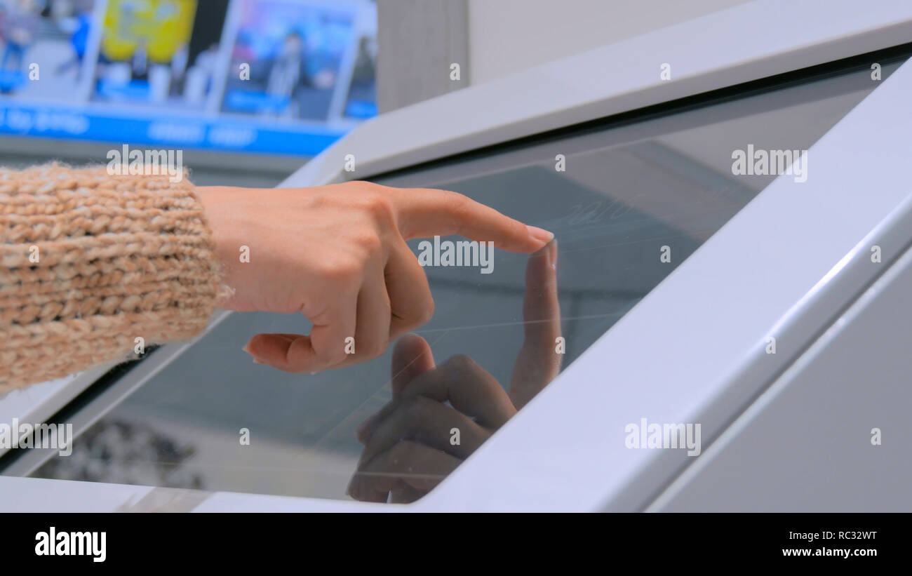Close up shot of woman hand using interactive touchscreen display at ...