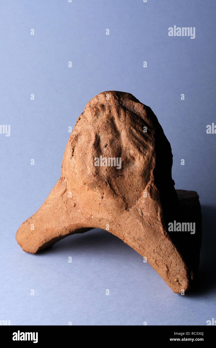 Antefixes of clay with tile part representing female head with long wavy hair. Height 7, 9 cm Width 6, 4 cm. ( 1st CE ) Roman period from the ' Fish House ' - Archaeological site of Complutum in Alcalá de Henares ( Madrid ). SPAIN. Stock Photo