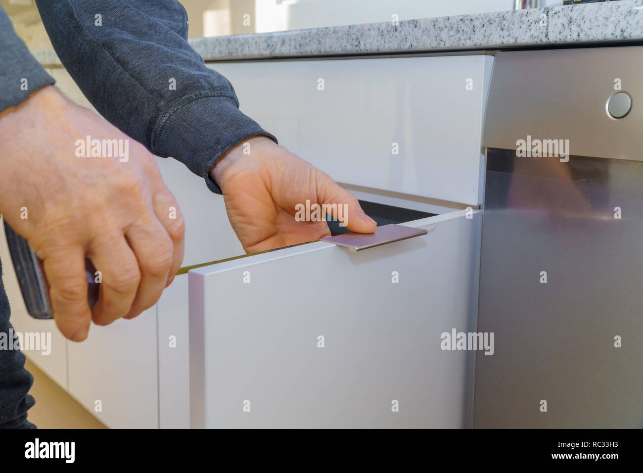 Hand on handle installation of door handles on opening door in
