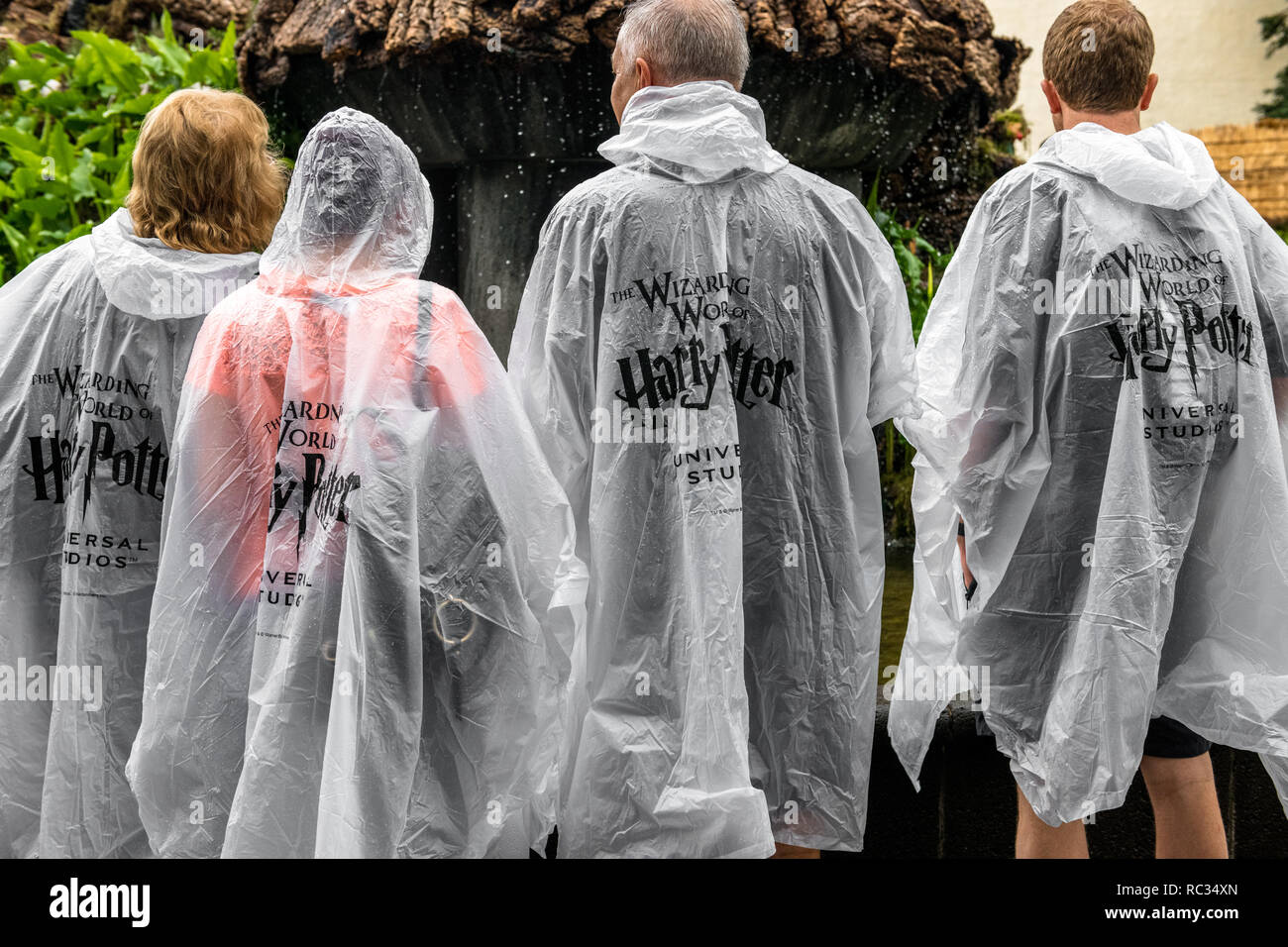 Tourist in the rain wearing "The Wizarding World of Harry Potter" clear  poncho Stock Photo - Alamy