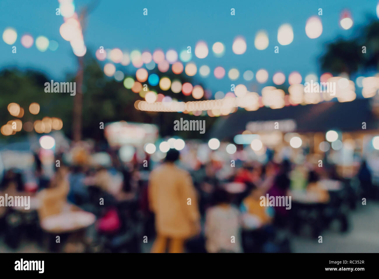 blurred background at night market festival people walking on road Stock  Photo - Alamy
