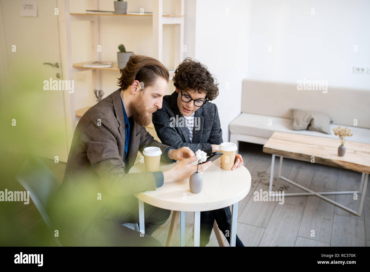Busy managers discussing project in cafe Stock Photo
