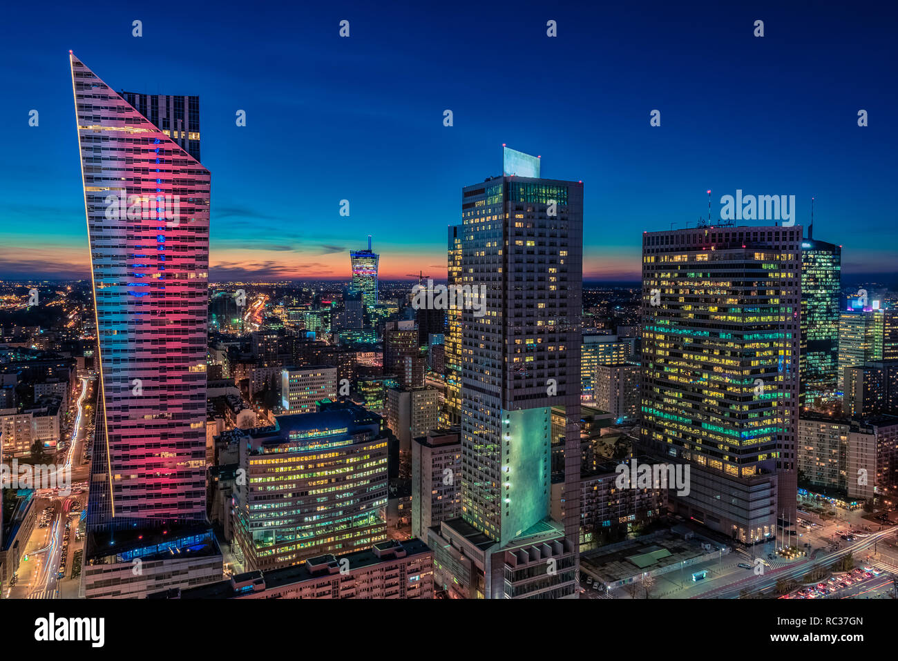 Warsaw cityscape. Panoramic view on the illuminated city buildings at night in capital of Poland. Urban nightscape. Stock Photo